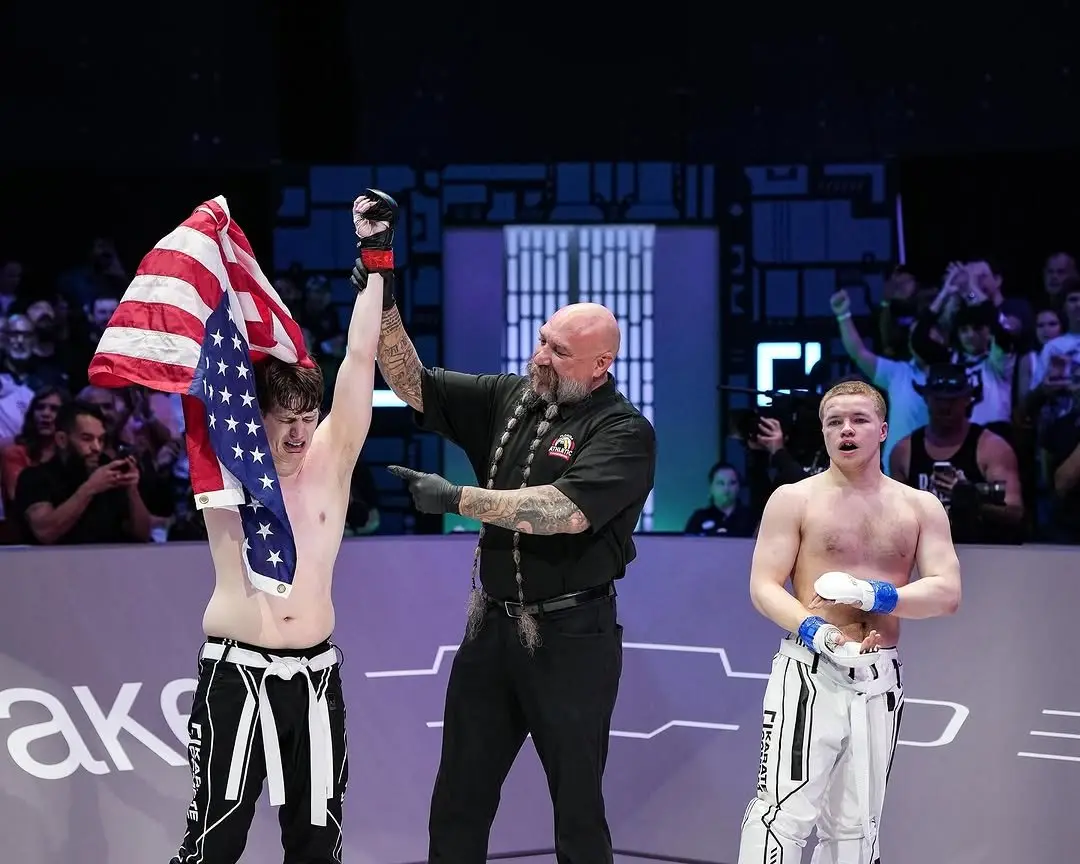 Ben Davis celebrating with a US flag after a Karate Combat fight